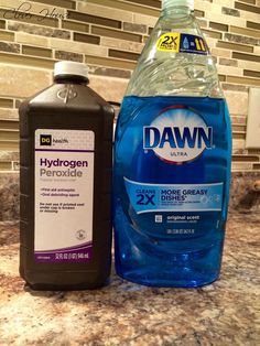 a bottle of dawn water next to a gallon of dishwasher detergent on a kitchen counter