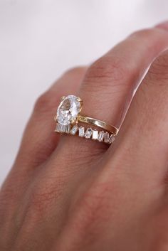 a woman's hand with a ring on it and a diamond in the middle