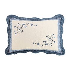 a blue and white pillow with flowers on it