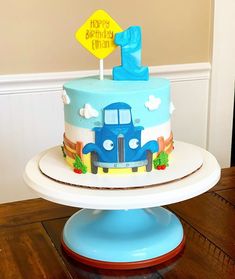 a blue birthday cake with a number one on top