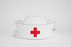 a white paper crown with a red cross on the front and side, cut out