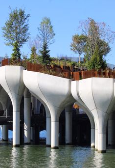 the bridge is designed to look like it's going over water with trees growing on top