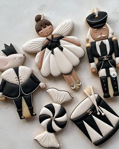 several decorated cookies in the shape of people