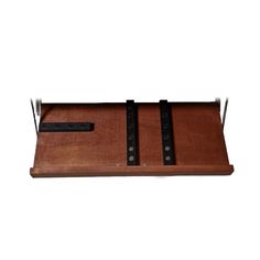 a wooden tray with two leather straps on it