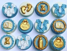 baby shower cupcakes are decorated with gold and blue icing