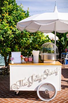 a food cart with an umbrella over it