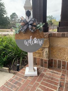 a welcome sign with a bow on it