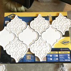 a package of decorative tiles sitting on top of a table