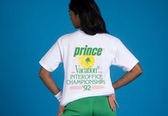 a woman in green shorts and a white t - shirt with the word prince on it