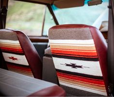 two seats in the back of a car with an american flag seat cover on it