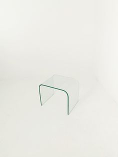 a glass table sitting on top of a white floor