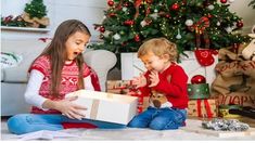 two young children opening a christmas present box