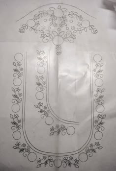 the letter u is made up of fruit and flowers on white paper with black ink