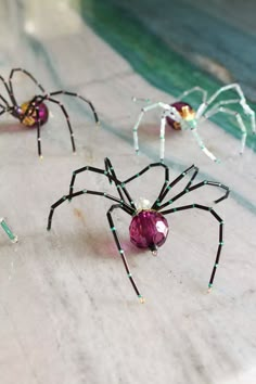 three spider figurines sitting on top of a table