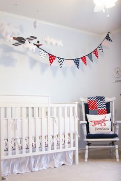 a baby's room decorated in red, white and blue