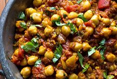 a bowl filled with chickpeas and tomato sauce