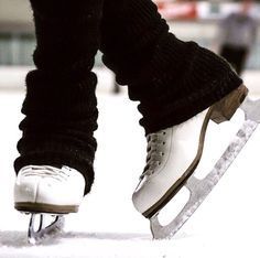 the legs and feet of a person skating on ice