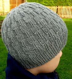 a close up of a child wearing a knitted hat