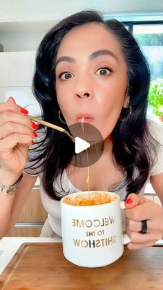 a woman is eating from a bowl with chopsticks in her hand and the words welcome to the shitshow written on it