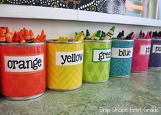 colorful crayons are lined up in tins with the word orange on them