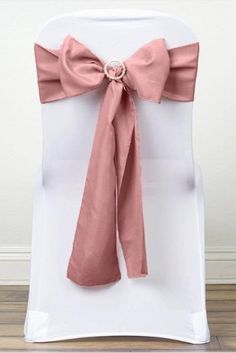 a white chair with a pink bow on it