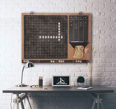 a desk with a laptop on it in front of a wall mounted calendar and clock