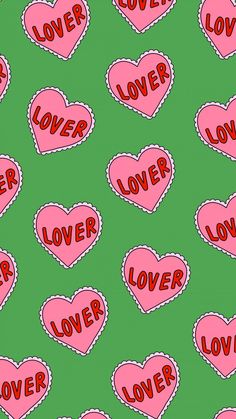 pink hearts with the word love spelled in red on a green background seamless pattern