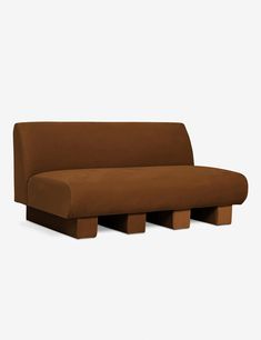 a brown couch sitting on top of a wooden block