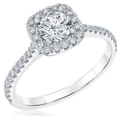 a white gold engagement ring with an oval halo setting and pave set diamonds around the band