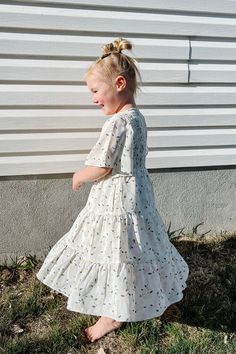 Introducing the Briggs Dress - the ultimate dreamy, flowy, and fabulous addition to your little's wardrobe! With its midi length, flowy sleeves, and v neckline, this dress is perfect for twirling around. But wait, there's more! The Briggs Dress also features a stunning floral pattern and tiered skirt detail, making it the perfect little girls dress. Dont forget to grab the adult version and match with your mini! *Relaxed fit* Material Content: Self: 100% Polyester // Lining: 100% Rayon Material Matching Mom, Flowy Sleeves, Mom Dress, Tiered Skirt, Girls Dress, Boutique Clothing, Perfect Dress, Midi Length