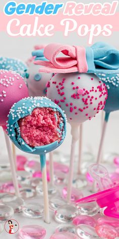 pink and blue cake pops with sprinkles on them