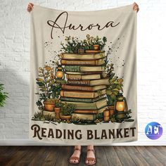 a woman is holding up a reading blanket