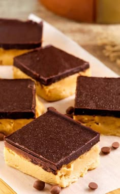 chocolate and peanut butter squares on parchment paper