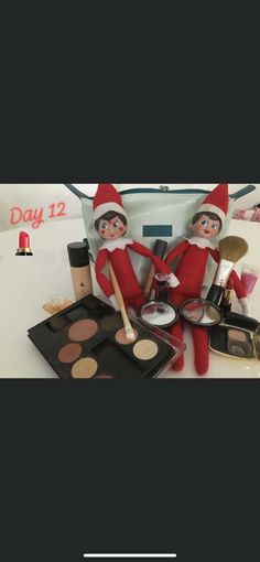 two elfs sitting on top of a table with makeup