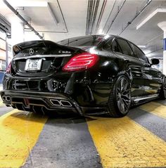 a black car parked in a parking garage