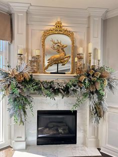 a fireplace decorated with greenery and candles