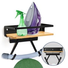 an ironing board with a green sprayer on it next to a black shelf