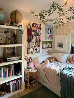 a bed room with a neatly made bed and lots of books on the shelves next to it