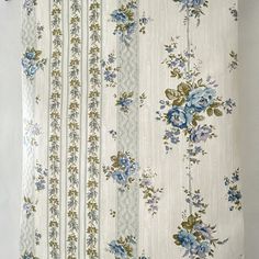 an old curtain with blue flowers on it