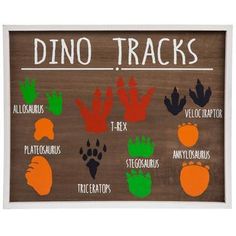 a wooden sign that says dino tracks with different types of handprints on it