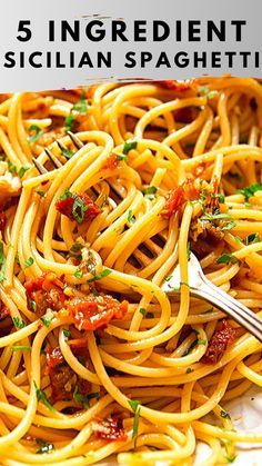 a plate full of spaghetti with sauce and parsley