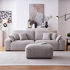 a living room with a couch and ottoman