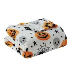 a white blanket with halloween pumpkins and bats on it