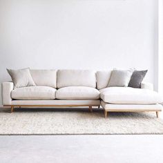 a white couch sitting on top of a rug