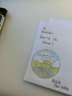 a piece of paper with the words, a better world is near and a pen next to it