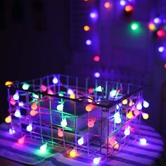 a basket filled with colorful lights on top of a table