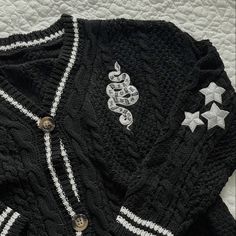 a black sweater with white and silver stars on it