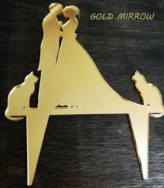 a couple kissing in the middle of a horse shaped ornament that says gold mirror