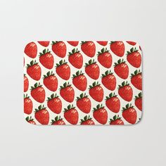 a bath mat with strawberries all over it