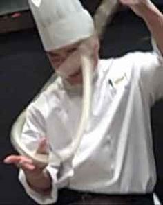 a man in a chef's hat is holding his hands up